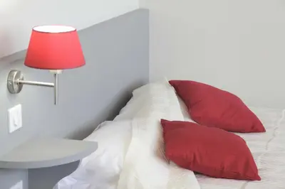 Un ou plusieurs lits dans un hébergement de l'établissement West Appart' Hôtel