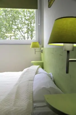 Un ou plusieurs lits dans un hébergement de l'établissement West Appart' Hôtel