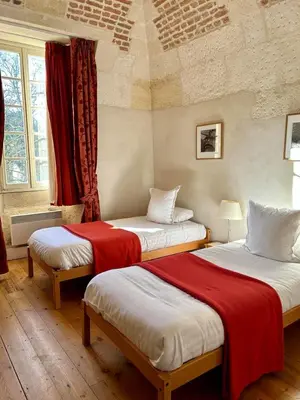 Un ou plusieurs lits dans un hébergement de l'établissement Les Chambres de l'Abbaye
