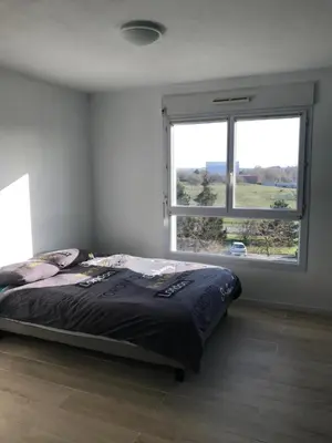 Un ou plusieurs lits dans un hébergement de l'établissement Appartement Futuroscope-J'