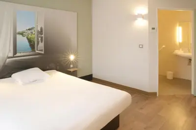 Un ou plusieurs lits dans un hébergement de l'établissement B&B HOTEL Angoulême