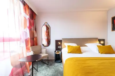 Un ou plusieurs lits dans un hébergement de l'établissement Best Western Premier Le Masq Hotel