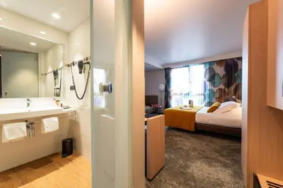 Un ou plusieurs lits dans un hébergement de l'établissement Best Western Premier Le Masq Hotel