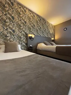Un ou plusieurs lits dans un hébergement de l'établissement Hôtel Le Valois, Cognac Centre