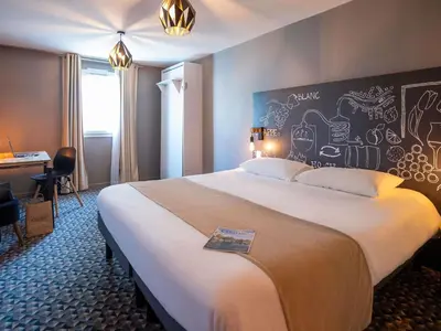 Un ou plusieurs lits dans un hébergement de l'établissement Ibis Styles Cognac