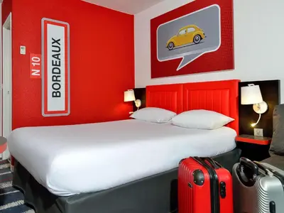 Un ou plusieurs lits dans un hébergement de l'établissement ibis Styles Angoulême Nord - hôtel restaurant