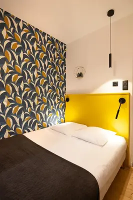 Un ou plusieurs lits dans un hébergement de l'établissement Hotel de La Paix