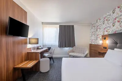 Un ou plusieurs lits dans un hébergement de l'établissement Hôtel Akena Poitiers Nord Futuroscope