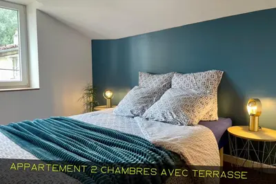 Un ou plusieurs lits dans un hébergement de l'établissement Les Appartements du Pont Joubert