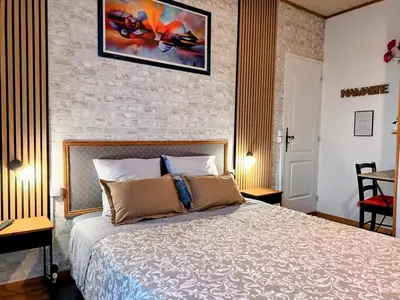 Un ou plusieurs lits dans un hébergement de l'établissement Le Clos des Passiflores - Chambres et Table d'Hôtes