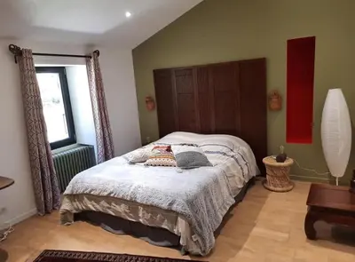 Un ou plusieurs lits dans un hébergement de l'établissement Gîte et Chambres d'Hôtes du Petit Moulin