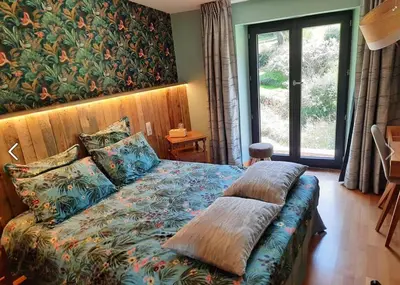 Un ou plusieurs lits dans un hébergement de l'établissement Gîte et Chambres d'Hôtes du Petit Moulin