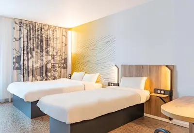 Un ou plusieurs lits dans un hébergement de l'établissement B&B HOTEL Poitiers Aéroport