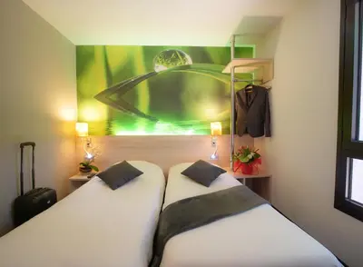 Un ou plusieurs lits dans un hébergement de l'établissement Hôtel Inn Design & Restaurant Rochefort