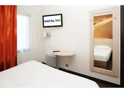 Un ou plusieurs lits dans un hébergement de l'établissement Hôtel Inn Design & Restaurant Rochefort