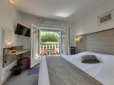 Un ou plusieurs lits dans un hébergement de l'établissement Contact Hôtel O'Nice Saintes