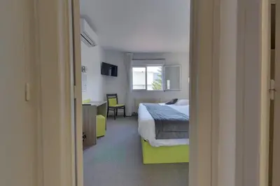 Un ou plusieurs lits dans un hébergement de l'établissement Contact Hôtel O'Nice Saintes
