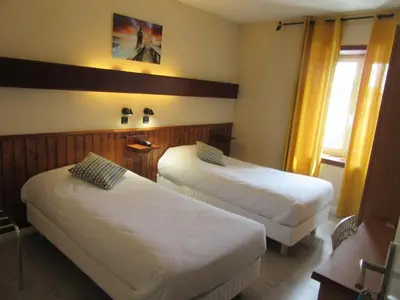 Un ou plusieurs lits dans un hébergement de l'établissement Hotel de France