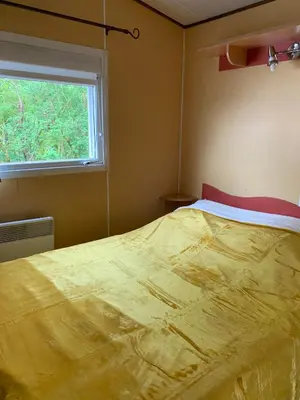 Un ou plusieurs lits dans un hébergement de l'établissement Camping de la ferme aux ânesses, mobil home myrtille