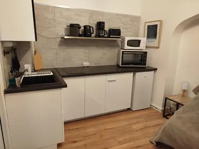 Cuisine ou kitchenette dans l'établissement Le Studio 64