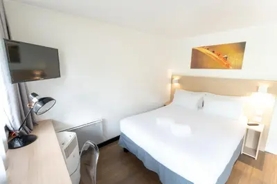 Un ou plusieurs lits dans un hébergement de l'établissement Hôtel Inn Design La Rochelle
