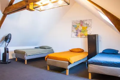 Un ou plusieurs lits dans un hébergement de l'établissement Les Olympiades - Magnifique Villa d'évasion