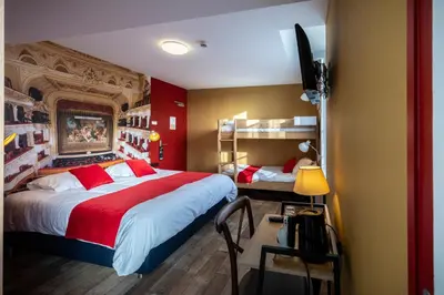 Un ou plusieurs lits dans un hébergement de l'établissement L'Auberge des Artistes