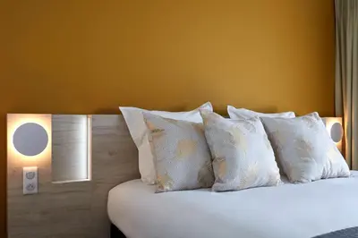 Un ou plusieurs lits dans un hébergement de l'établissement Hôtel Akena Chauray-Niort