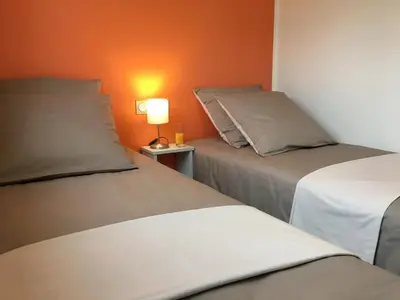 Un ou plusieurs lits dans un hébergement de l'établissement Mandarine la vallee des noyers