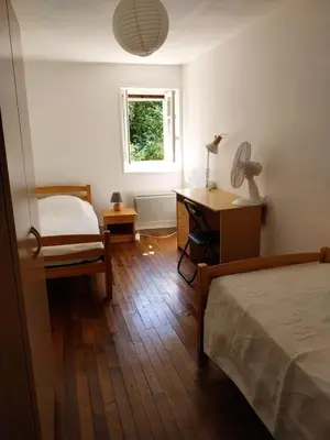 Un ou plusieurs lits dans un hébergement de l'établissement La maison du fermier