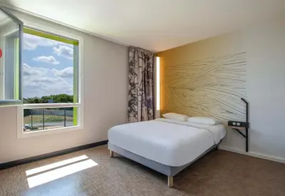 Un ou plusieurs lits dans un hébergement de l'établissement B&B HOTEL Saintes